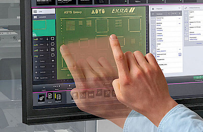Human hand over a monitor displaying a PCB board.