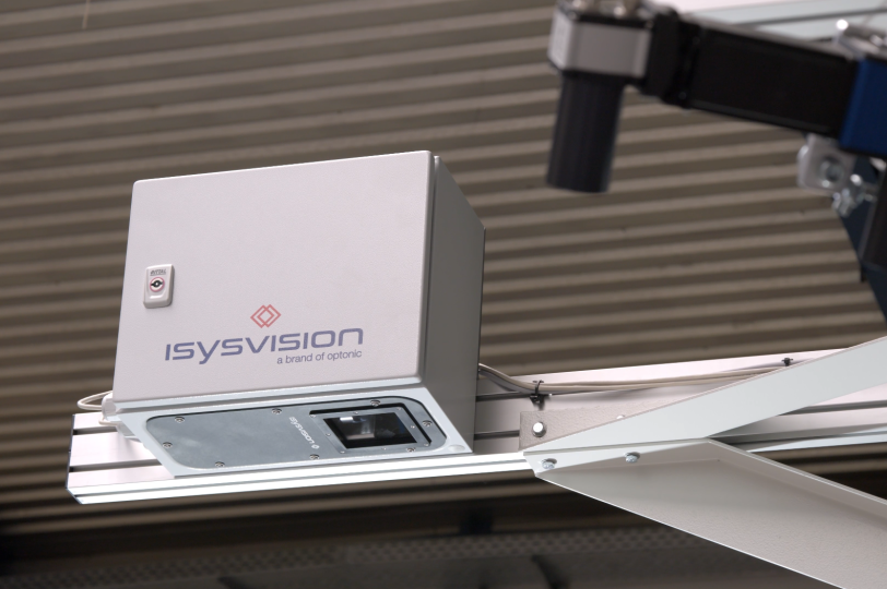 Human hand over a monitor displaying a PCB board.