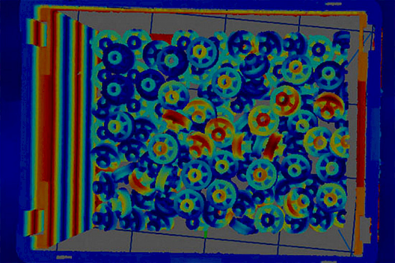 Thermal image of gears lying on top of each other in a box.
