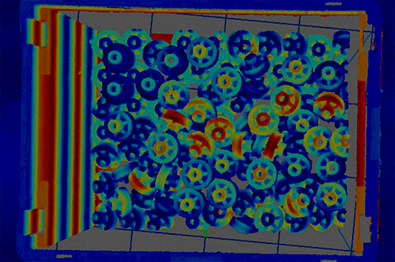 Wärmebild bildaufnahme von übereinander liegenden Zahnräder in einer Kiste.